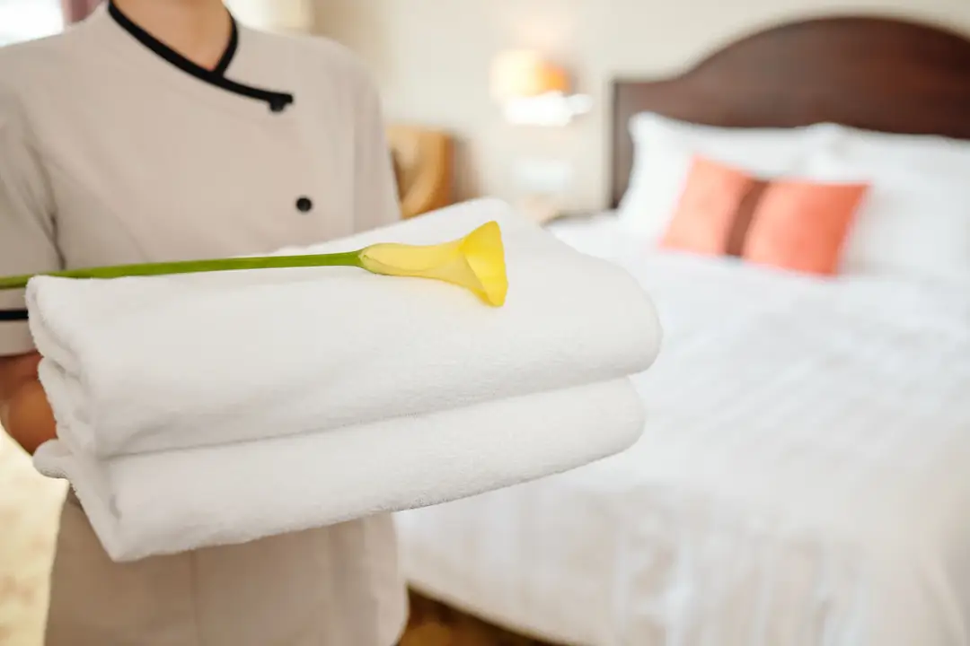 Hotel room service with towels and flowers